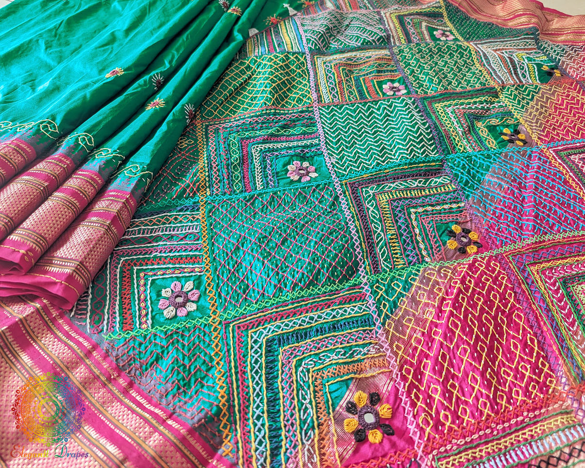 Intricate Lambani hand embroidery detail on emerald green silk saree