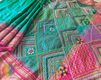 Intricate Lambani hand embroidery detail on emerald green silk saree