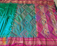 Traditional embroidered motif detail on emerald green Ilkal silk saree