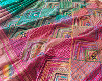 Pink palla close up on emerald green Ilkal silk saree highlighting Lambani embroidery