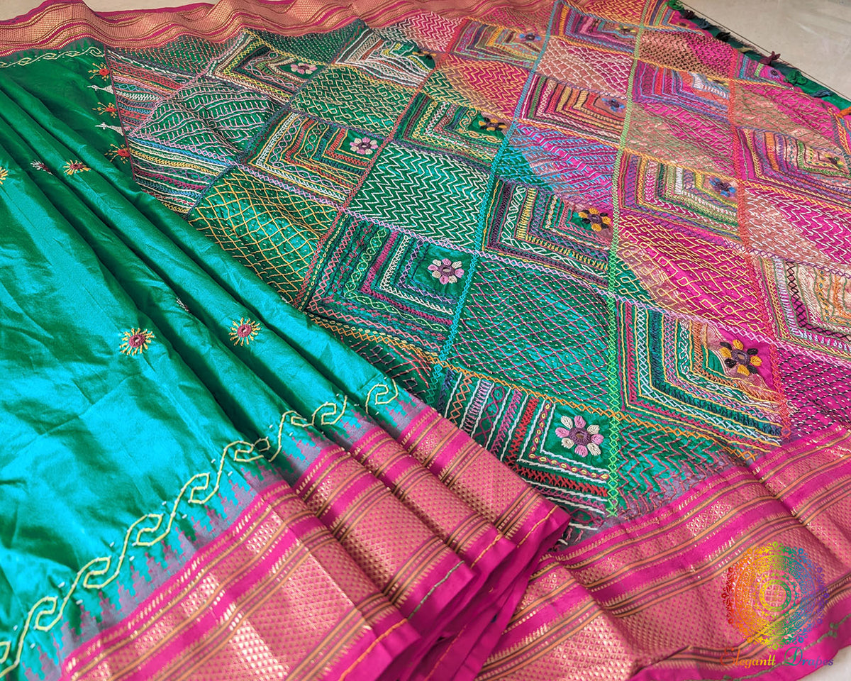 Pink border close up on emerald green Ilkal silk saree highlighting embroidery
