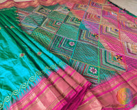 Pink border close up on emerald green Ilkal silk saree highlighting embroidery