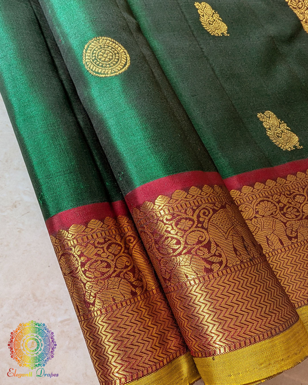 Detailed view of woven zari motifs on red border of Kanjivaram saree