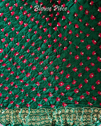 Matching green blouse piece with coordinated Nakshi border detailing