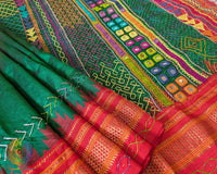 Red border close up on green Ilkal silk saree highlighting finish