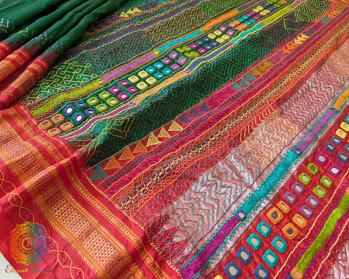 Red palla close up on green Ilkal saree showcasing Lambani embroidery