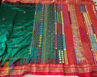 Deep Green Pure Ilkal Silk Saree showcasing the red palla and border alongside the traditional Sindur Lambani hand embroidery.
