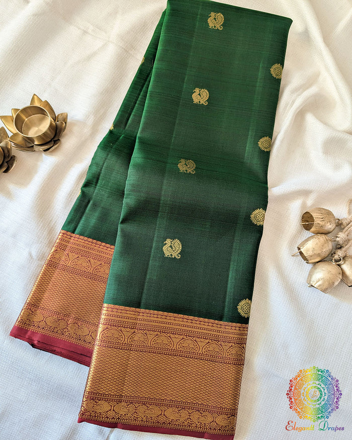 Green Pure Kanjivaram Handloom Silk Saree with 1gm Gold Zari displayed in a folded view, showcasing the rich green silk fabric and traditional golden zari detailing.