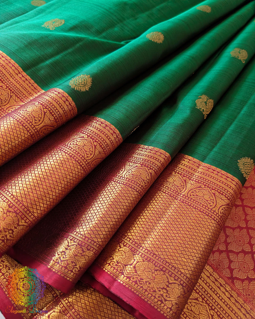 Detailed view of the pleats and gold zari design on the Green Pure Kanjivaram Handloom Silk Saree, showcasing the silk texture and traditional craftsmanship.