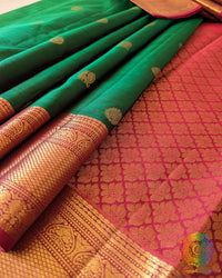 Close-up of the Green Kanjivaram Silk Saree border, highlighting the intricate gold zari weaving against the rich green silk fabric.