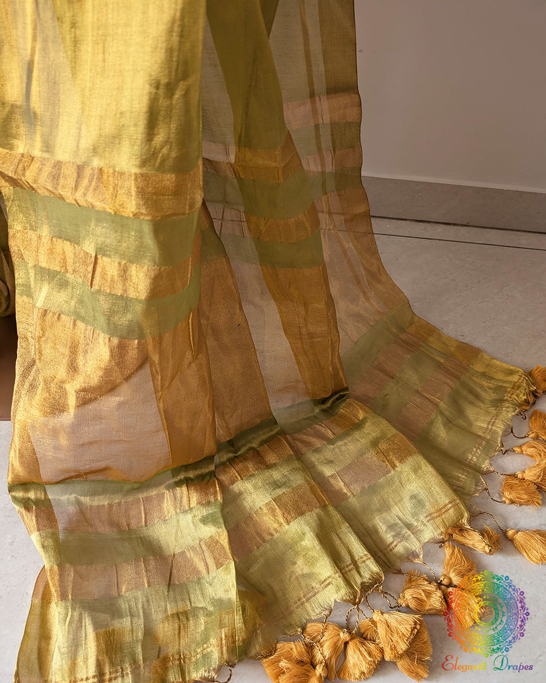 Pom pom detailing on green saree