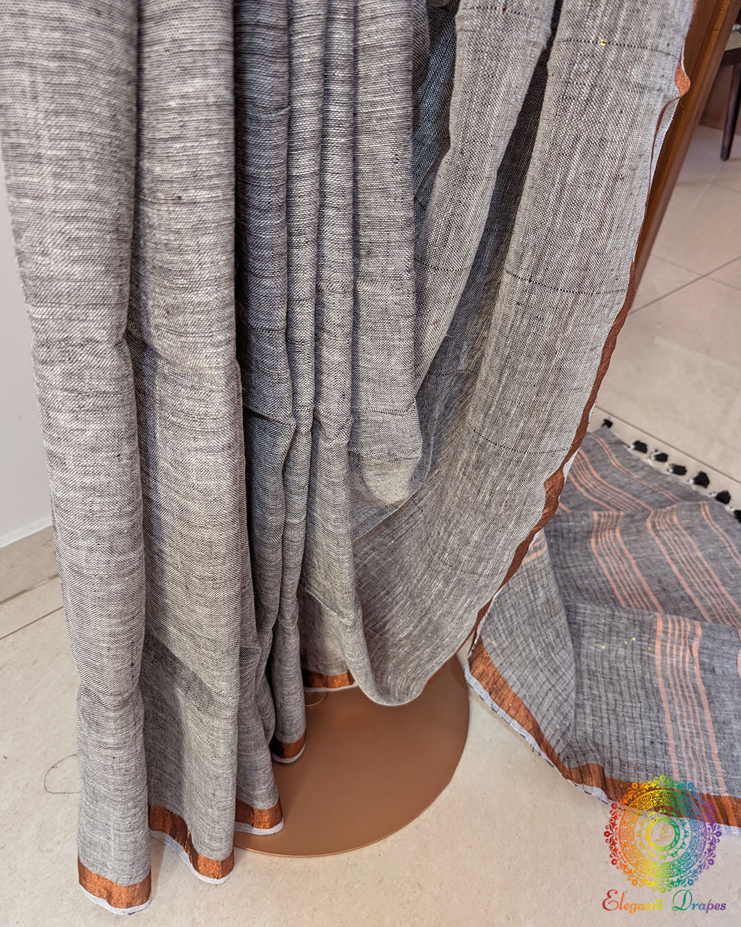 Pleats detail of grey linen saree showing texture and fall