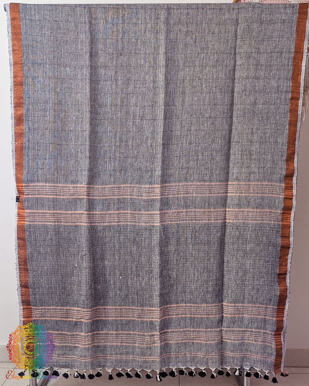 Full grey linen saree laid open showing overall design and layout