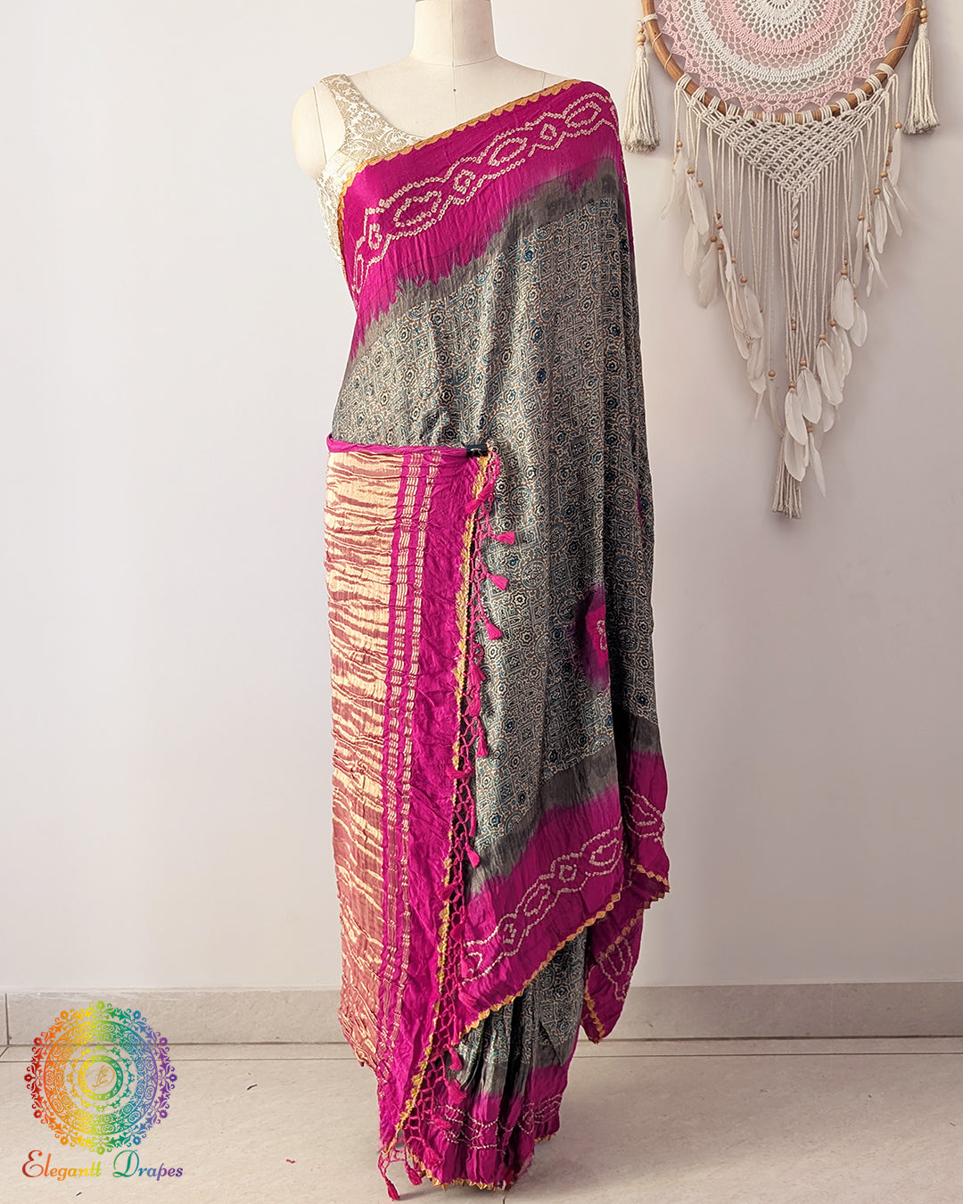 Grey Ajrakh saree on mannequin showcasing magenta bandhani palla detail