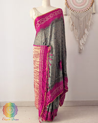 Grey Ajrakh saree on mannequin showcasing magenta bandhani palla detail