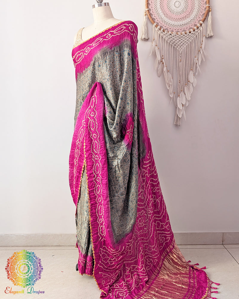 Side angle view of grey saree with magenta bandhani border highlighting drape