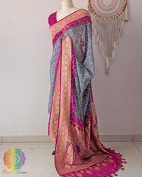Side angle view of grey saree with pink palla highlighting graceful fall