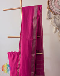 Hot pink Bengal cotton saree body close up highlighting fabric texture with zari border detail