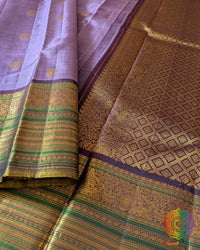 Close-up of wide green and gold zari border on Lavender Kanjivaram Silk Saree