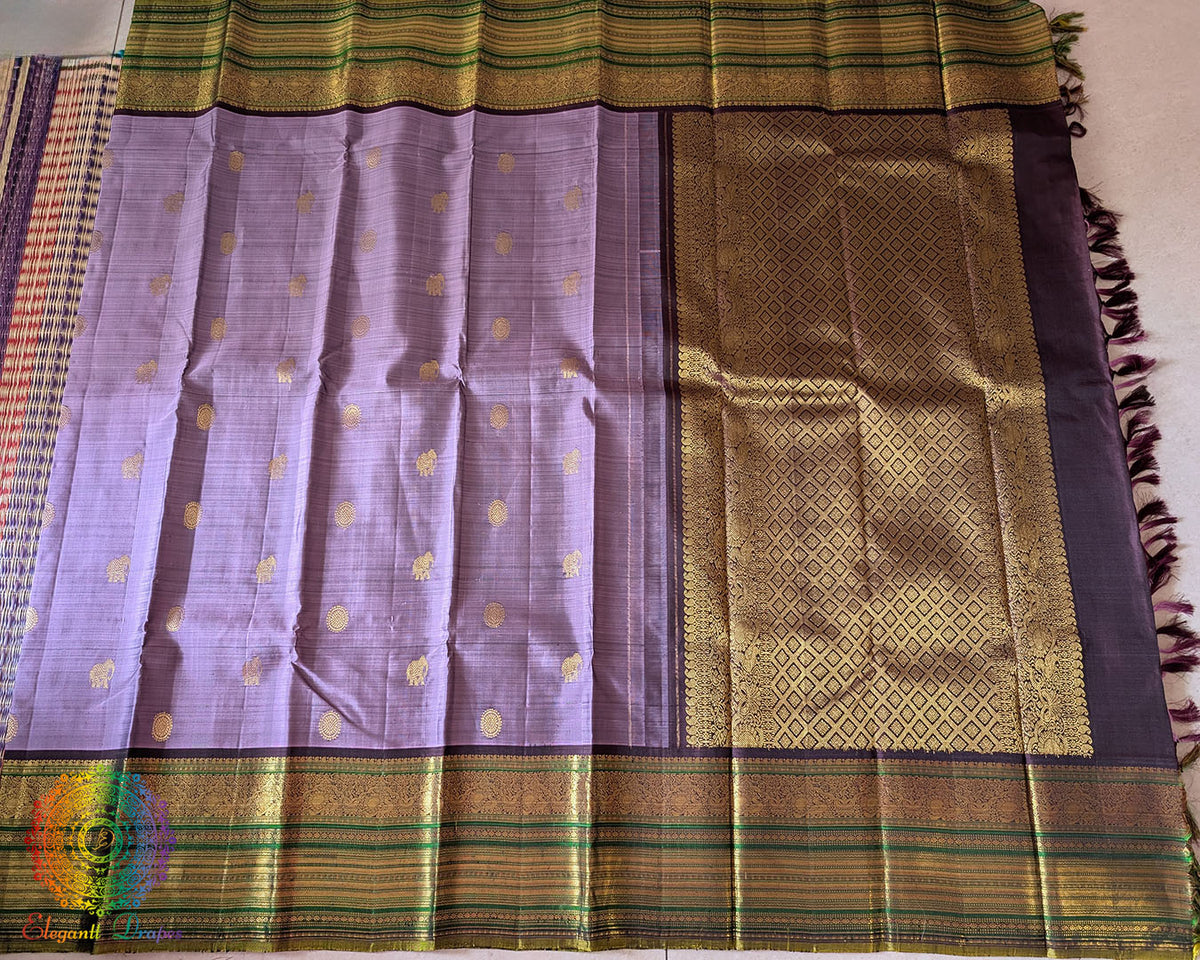 Detailed green and gold zari pallu on Lavender Pure Kanjivaram Silk Saree