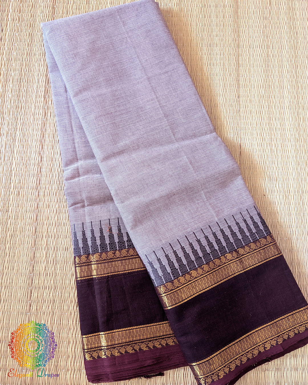 Folded lilac pink pure Kanchi cotton saree showing woven border detail