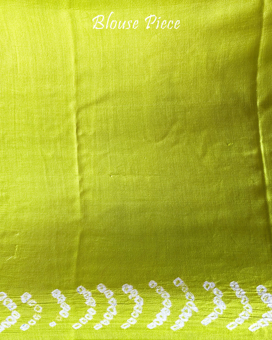 Matching blouse piece in lime green gaji silk fabric with bandhani detailing