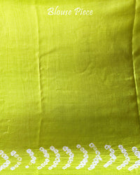 Matching blouse piece in lime green gaji silk fabric with bandhani detailing