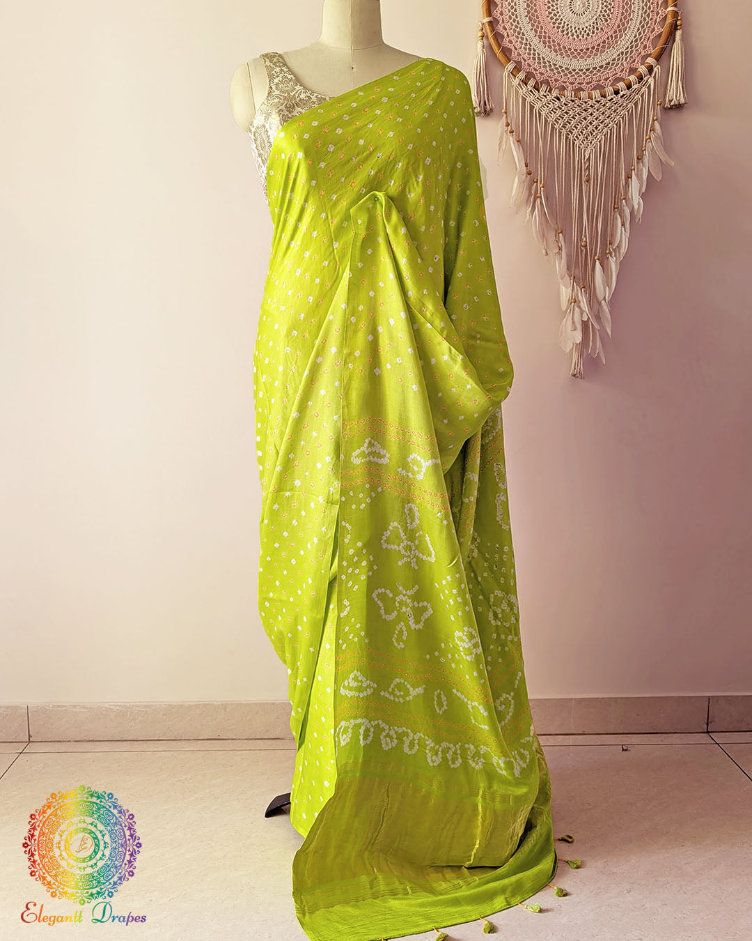 Lime green pure gaji silk saree with all-over bandhani dots on mannequin showing full drape