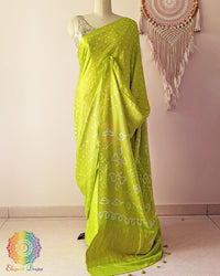 Lime green pure gaji silk saree with all-over bandhani dots on mannequin showing full drape