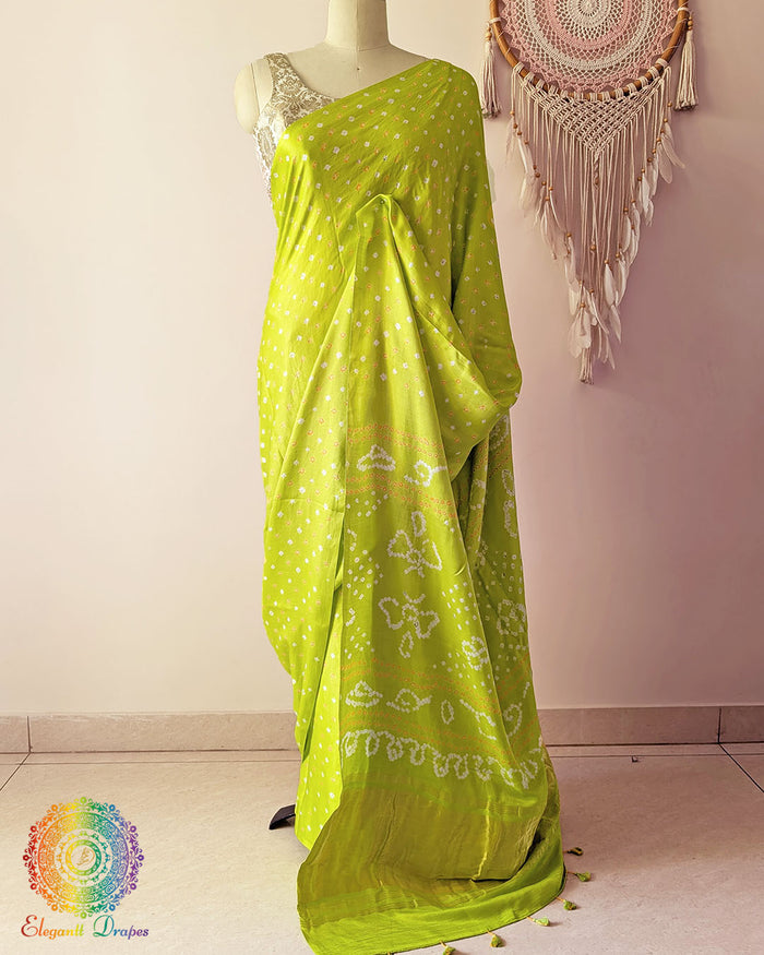 Lime green pure gaji silk saree with all-over bandhani dots on mannequin showing full drape