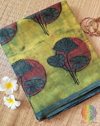 Lime Green Nashpal Pomegranate Ajrakh Modal Tussar Saree folded to display its fresh green shade and distinctive floral Ajrakh print.