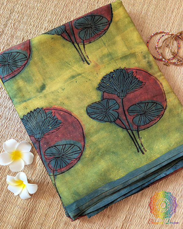 Lime Green Nashpal Pomegranate Ajrakh Modal Tussar Saree folded to display its fresh green shade and distinctive floral Ajrakh print.