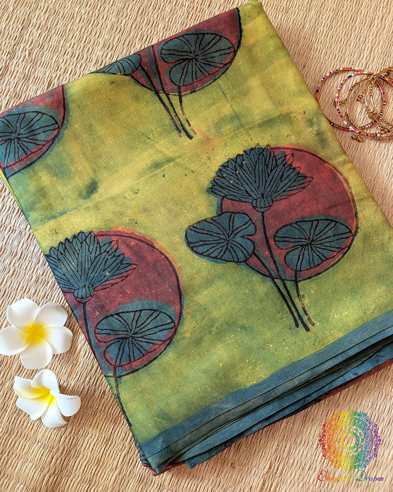 Lime Green Nashpal Pomegranate Ajrakh Modal Tussar Saree folded to display its fresh green shade and distinctive floral Ajrakh print.