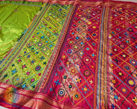 Full view of the Lime Green Pure Ilkal Silk Saree with Sindur Lambani Handwork, featuring the contrasting red palla and border against the vibrant green body.