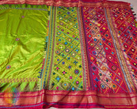 Lime Green Pure Ilkal Silk Saree highlighting the red palla and border alongside the colourful Sindur Lambani hand embroidery.
