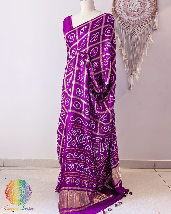 Berry purple gaji silk Gharchola saree showcasing elegant drape and traditional Bandhani design