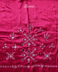 Sleeve detail of rani pink Mashru silk blouse piece featuring traditional Kutch mirror work