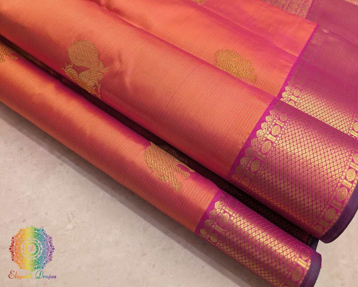 Close up of magenta orange shot Kanjivaram silk saree showing silk weave and zari detail