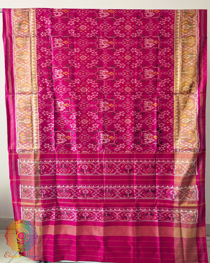 Magenta Pink Handwoven Mulberry Silk Rajkot Patola Saree – Full Saree View displaying the complete saree with its striking magenta pink shade, traditional Patola-inspired motifs and beautiful silk texture, reflecting the heritage of Gujarati weaving.
