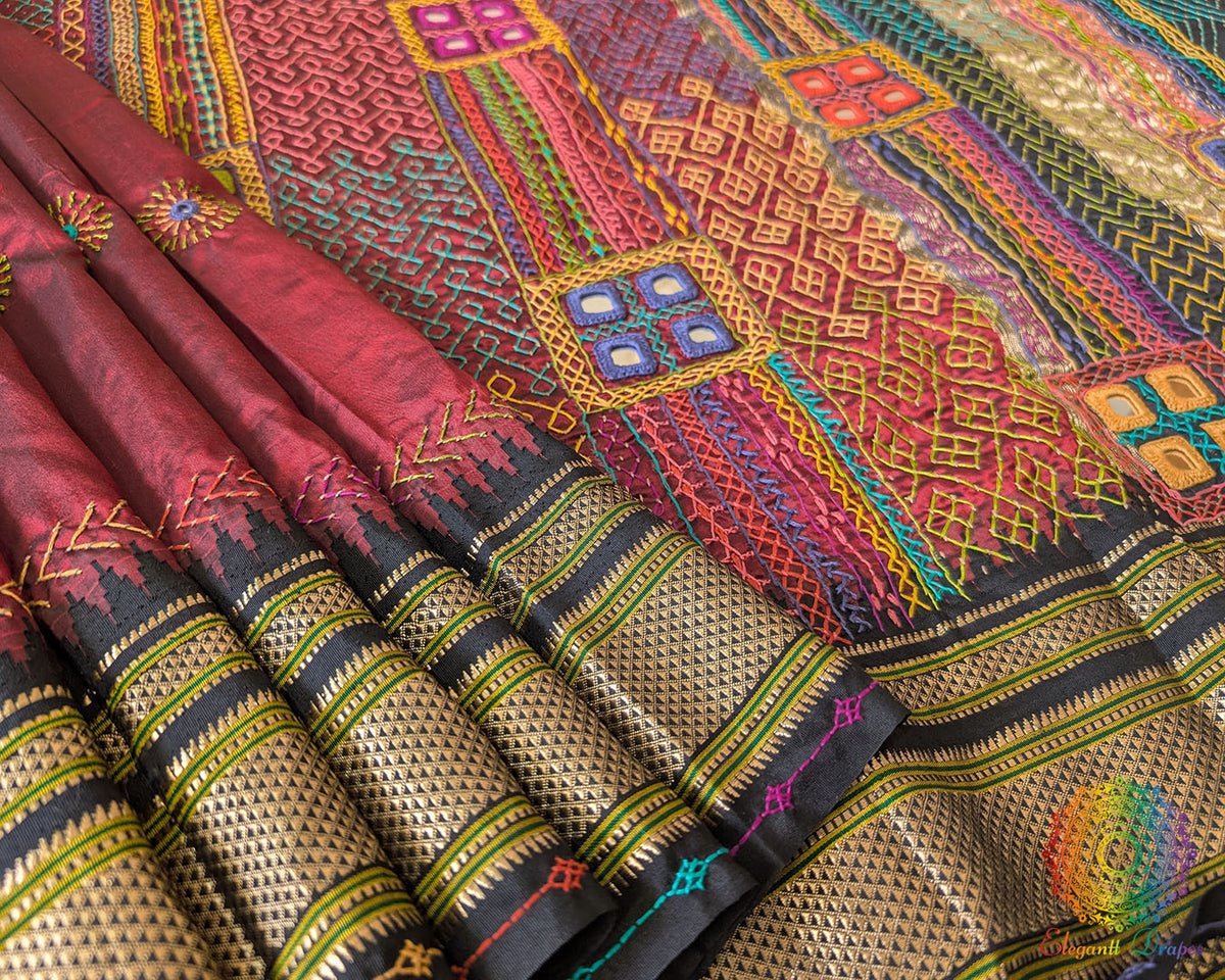Black border close up on maroon Ilkal silk saree highlighting finish