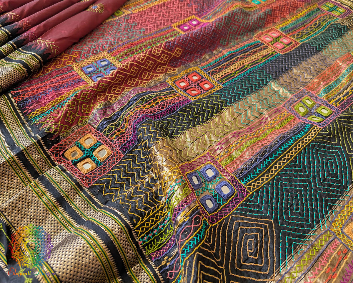 Black palla close up on maroon Ilkal saree showcasing Lambani embroidery
