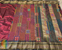 Full maroon Ilkal silk saree laid flat showing black palla and border