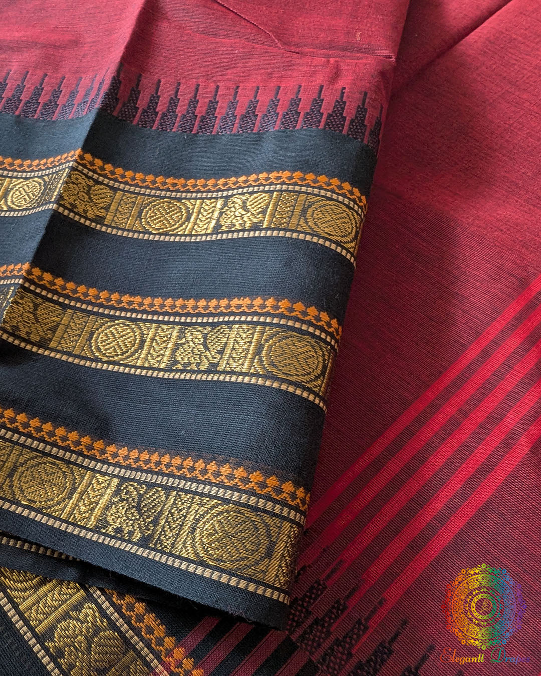 Maroon Kanchi cotton saree border close up highlighting black woven detailing and texture
