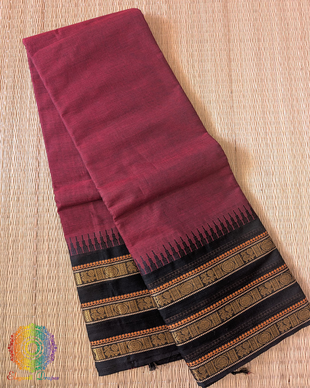 Folded maroon pure Kanchi cotton saree showing black border detail