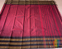 Full maroon Kanchi cotton saree laid open showcasing black border and overall design