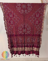 Close up of maroon red bandhani gaji silk dupatta showing tie dye and nakshi border detail