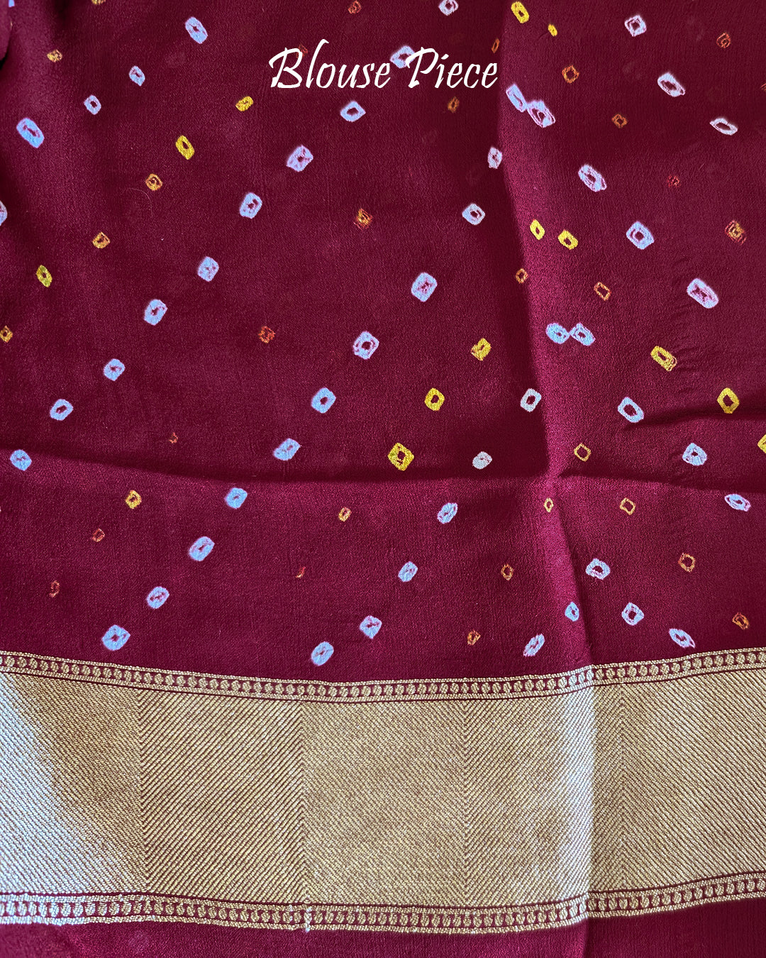 Matching blouse piece in maroon Banarasi khaddi georgette fabric showing weave detail