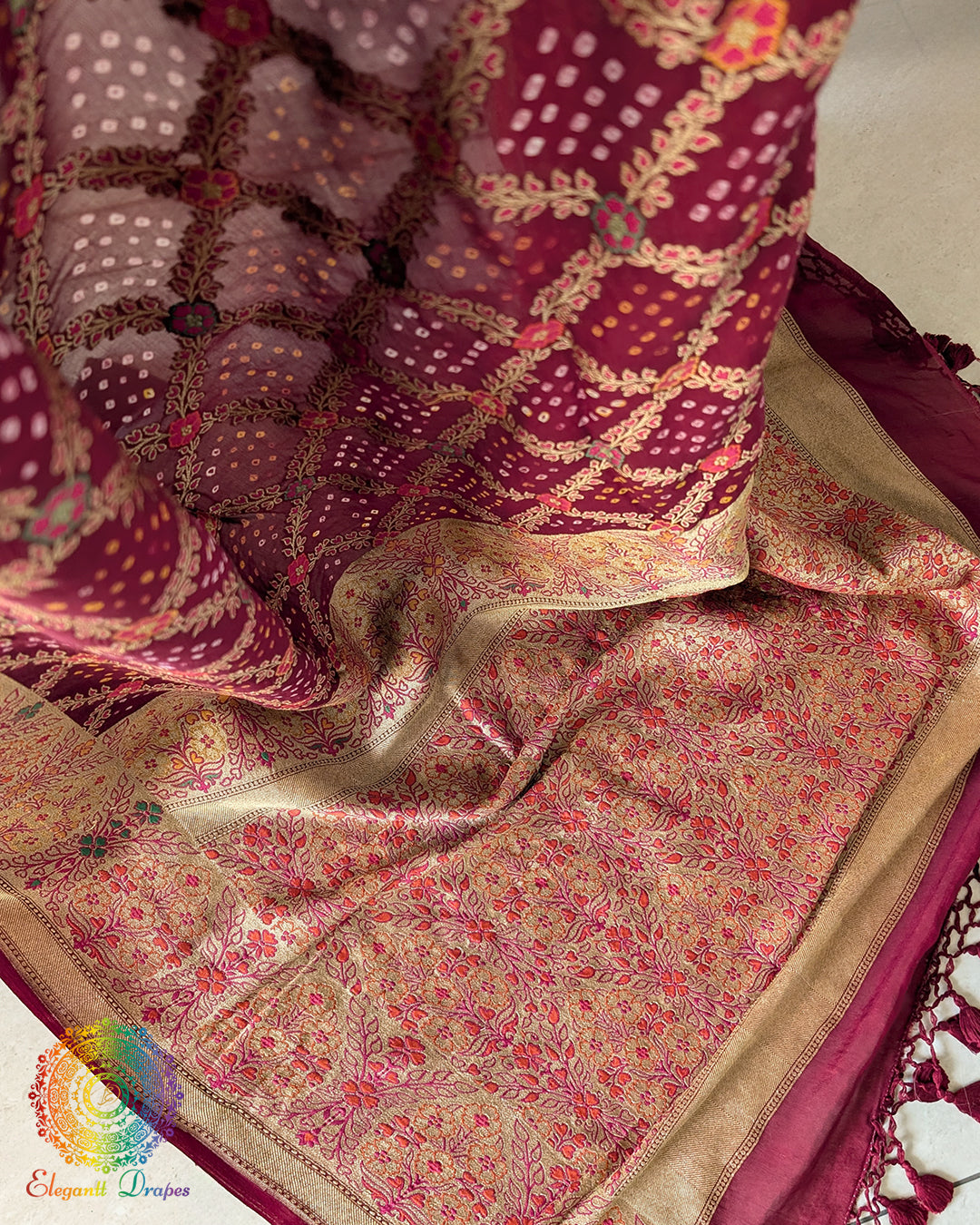 Palla close up on maroon georgette saree highlighting bandhani and meenakari detailing