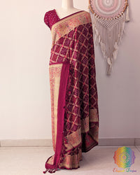 Maroon Banarasi saree on mannequin showcasing meenakari weave detail