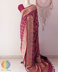 Maroon Banarasi khaddi georgette bandhani meenakari saree on mannequin showing full drape